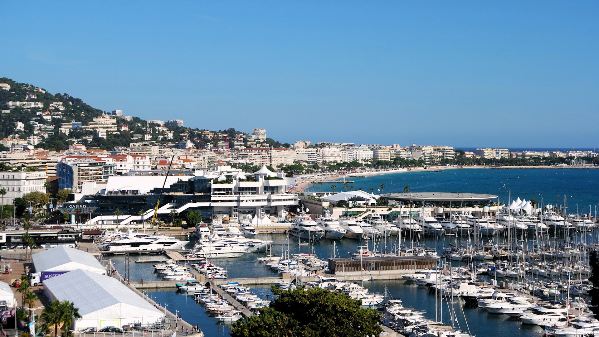 Cannes harbour with yachts and panoramic views across the French Riviera bay