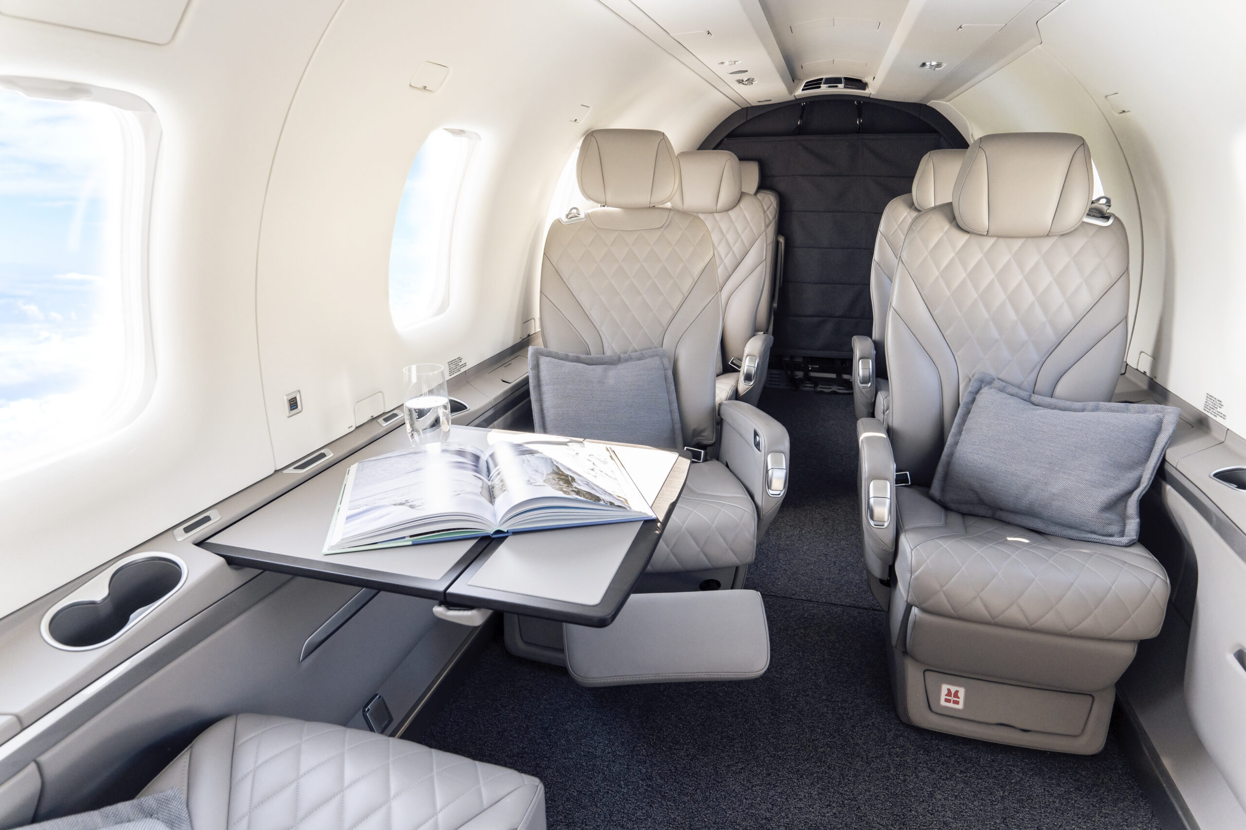 Exclusive cabin of a Lohn Aviation Pilatus PC-12 NGX with light leather seats during a private flight within Europe.